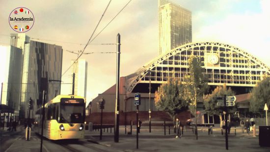 A Manchester tram passing Manchester Central with the Hilton in the background.