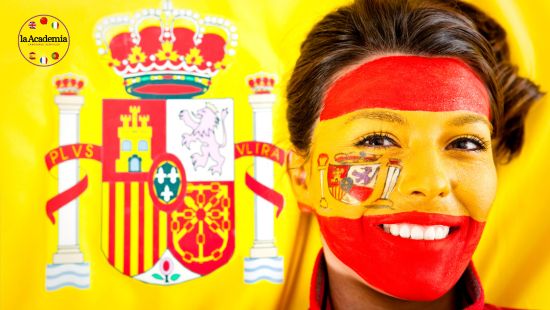 A young woman with the Spanish flag painted on her face.
